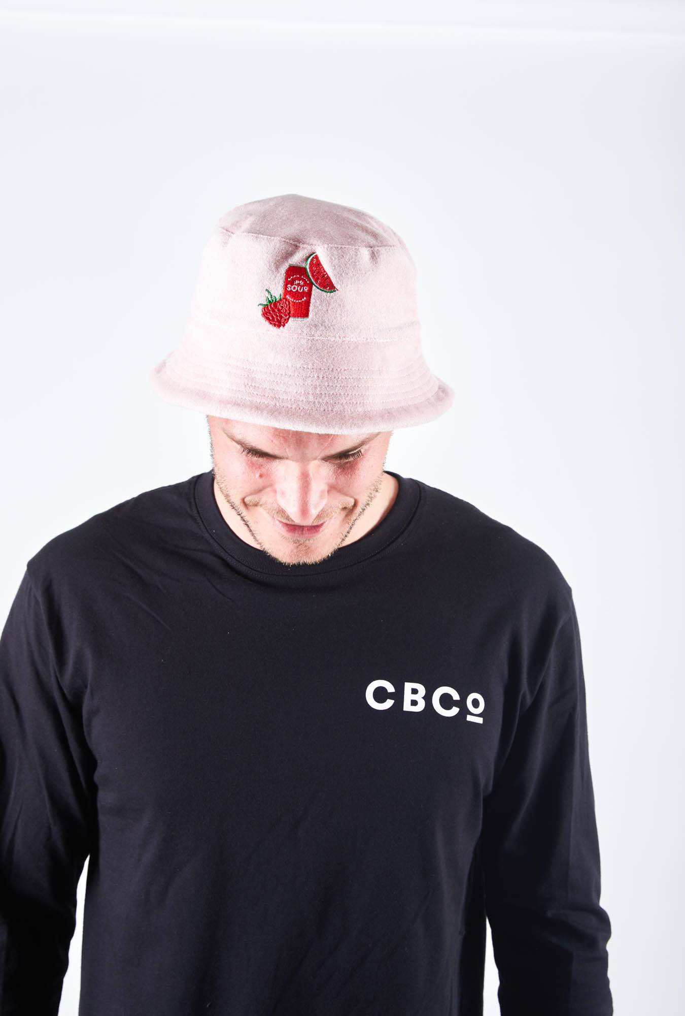 Man is wearing Colonial Brewing Co, CBCO pink bucket hat with an image of the South West Sour Beer Can, watermelon and strawberries on it.