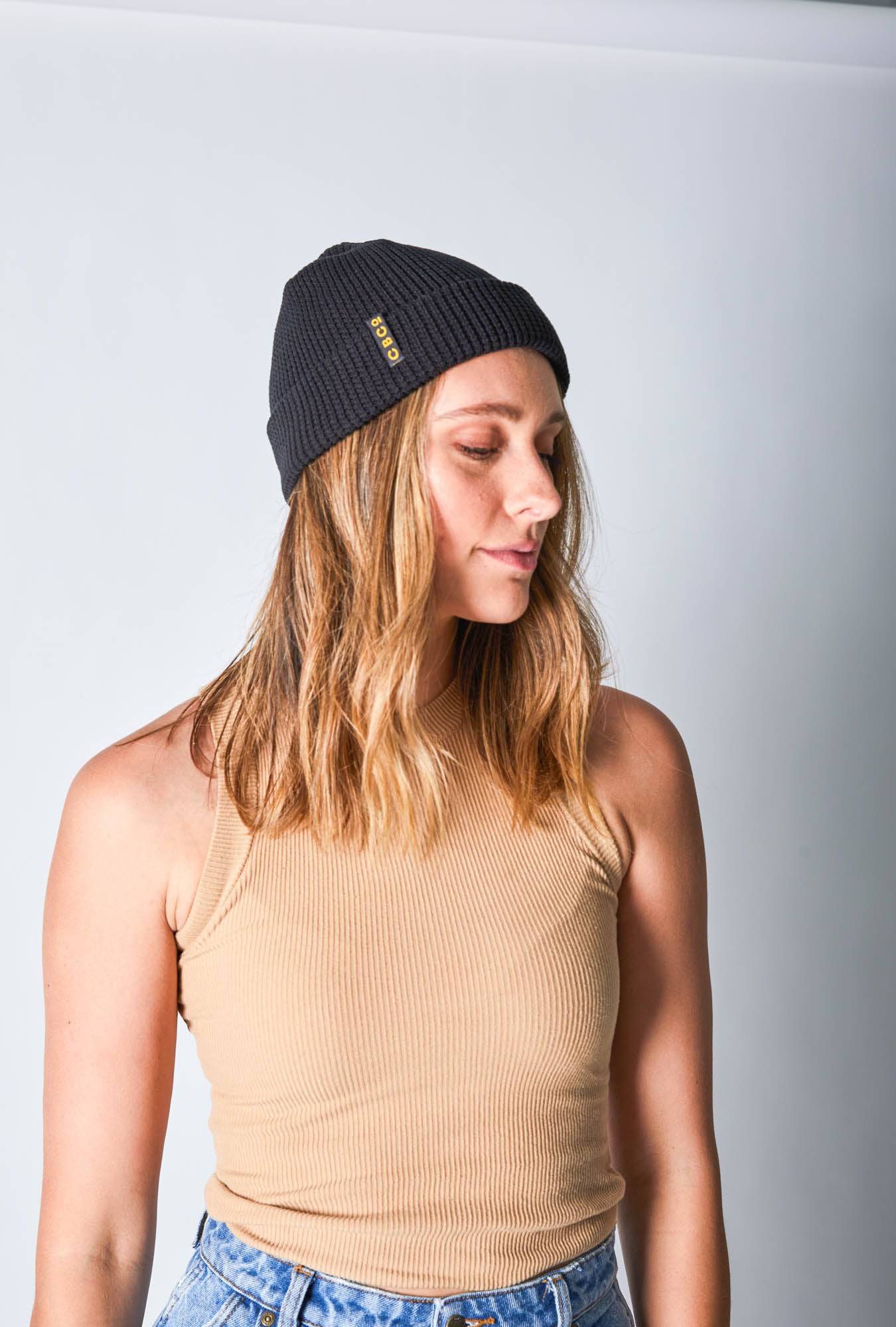 Side view of a woman in a black-colored beanie featuring Billy Bones available at CBCO
